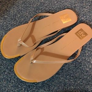 Tan and gold flip flop sandals